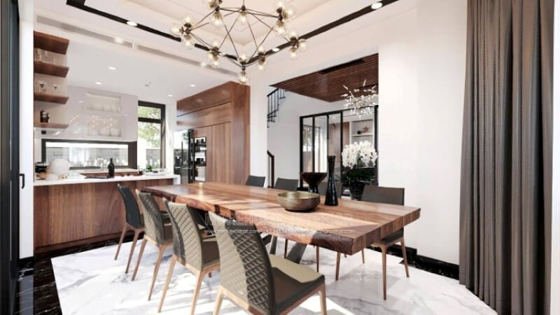 Ngoài điểm đặc biệt từ cách bố trí kệ trang trí, bàn đảo bằng đá granite màu trắng được thiết kế phô ra ngoài lại là điểm đáng chú ý, một mặt vẫn đảm bảo diện tích để chủ nhân có thể trưng bày món ăn thỏa mái, một mặt bạn lại có thể vừa nội trợ vừa có thể để mắt con học một cách dễ dàng. Thiết kế tủ bếp biệt thự sang trọng